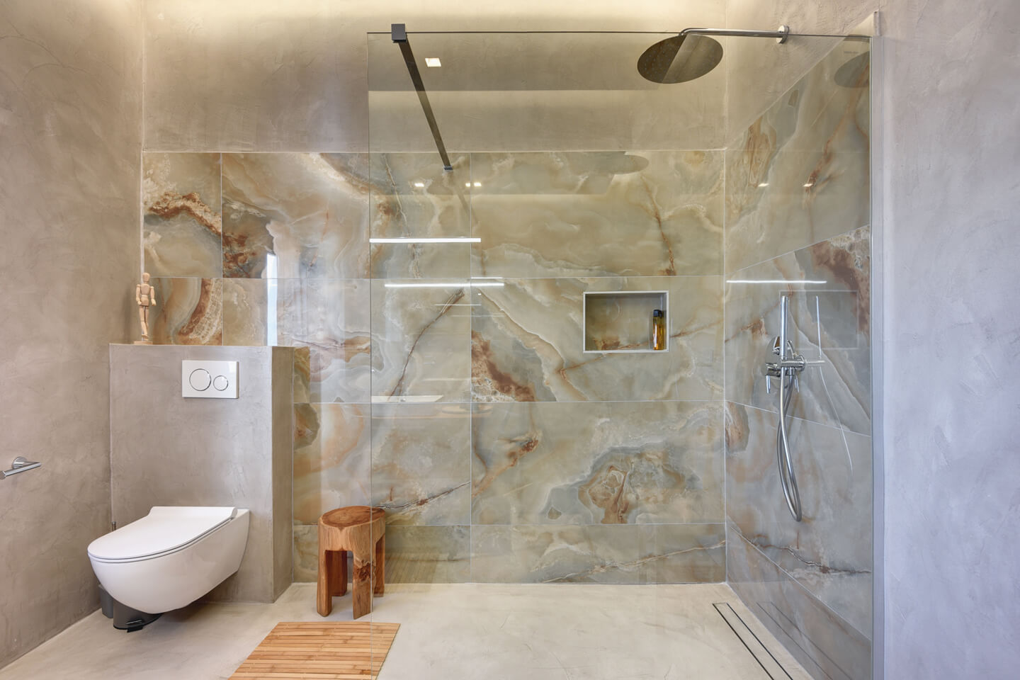 Walk in shower with warm marble decor